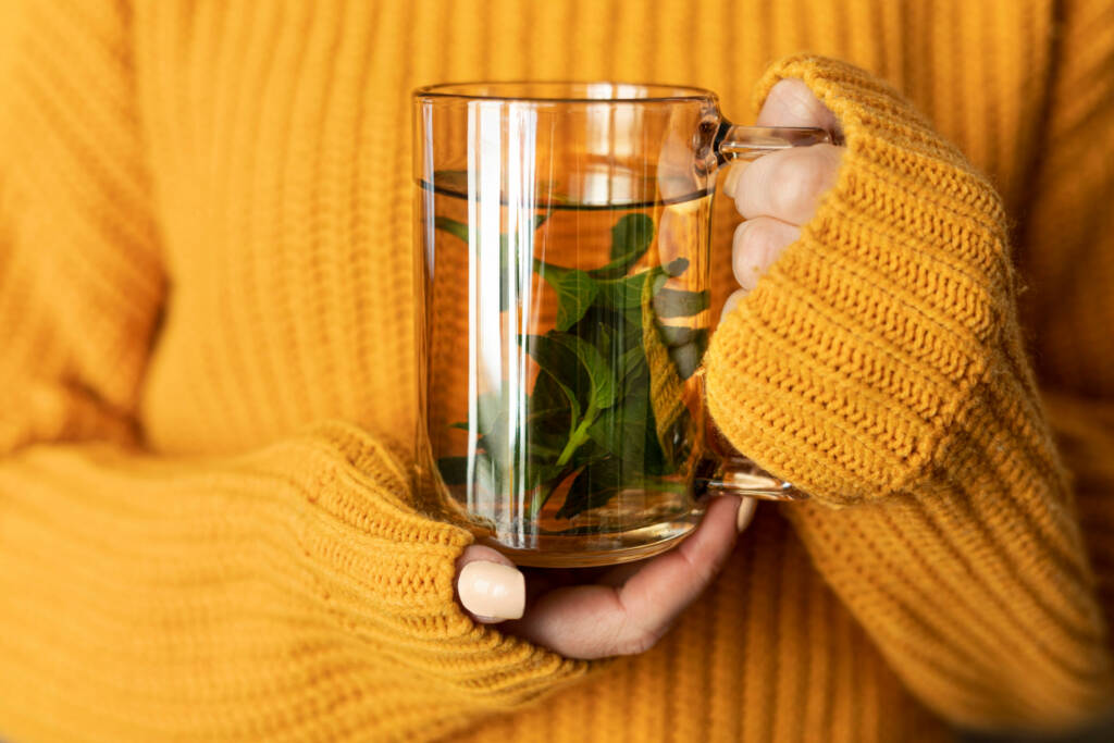 Woman holding teacup rosemary