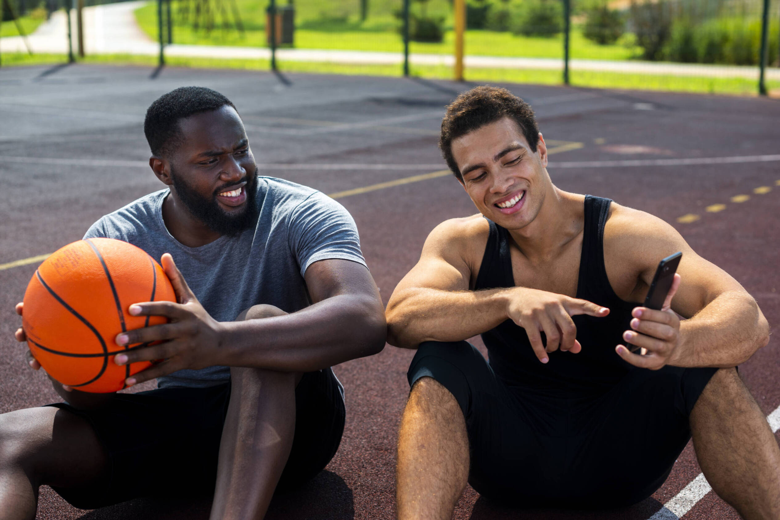 Two men resting after basketball