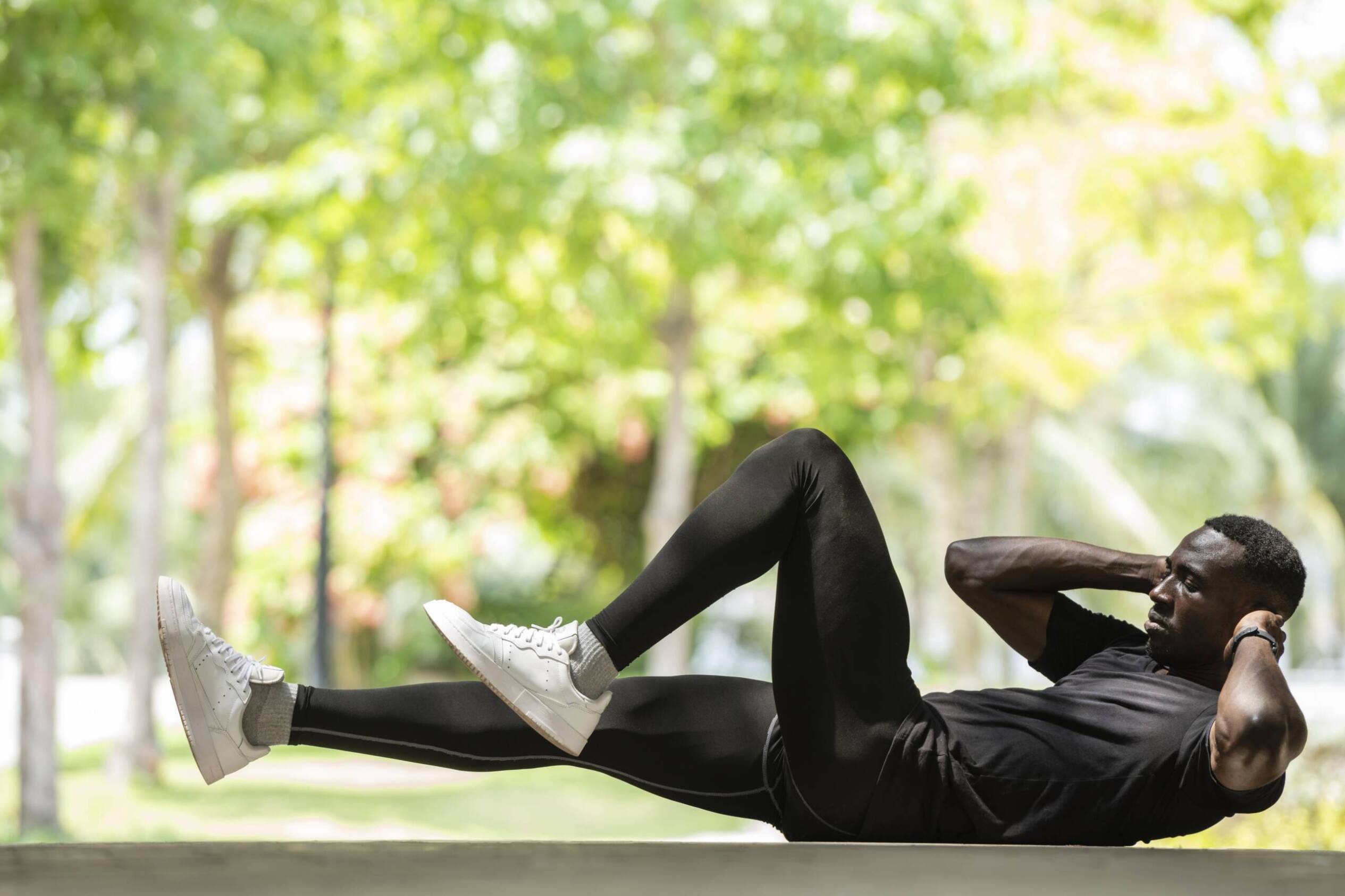 Man doing sit-ups outdoors