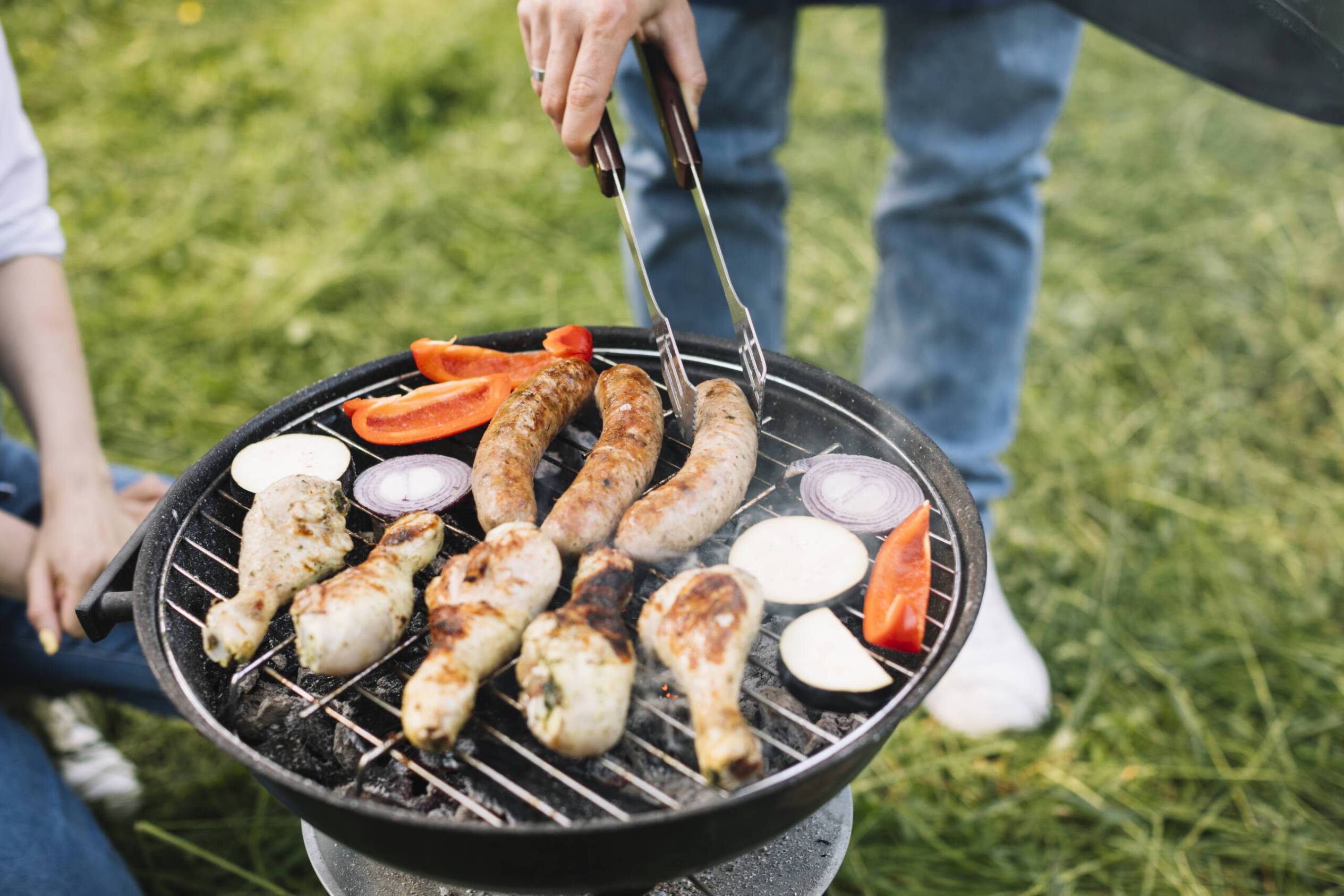 Person grilling seafood and meat