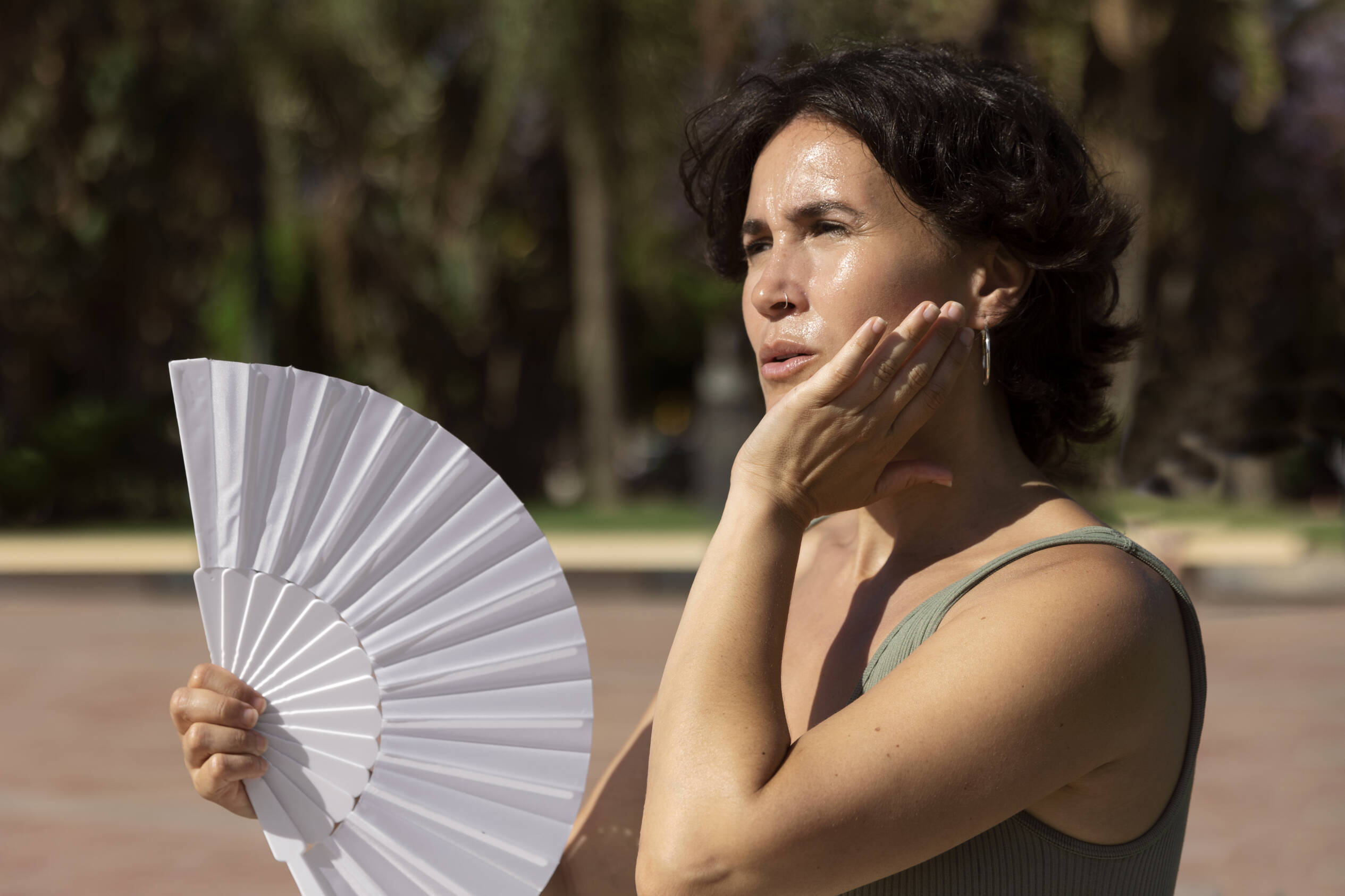Woman in hot weather using a handheld fan