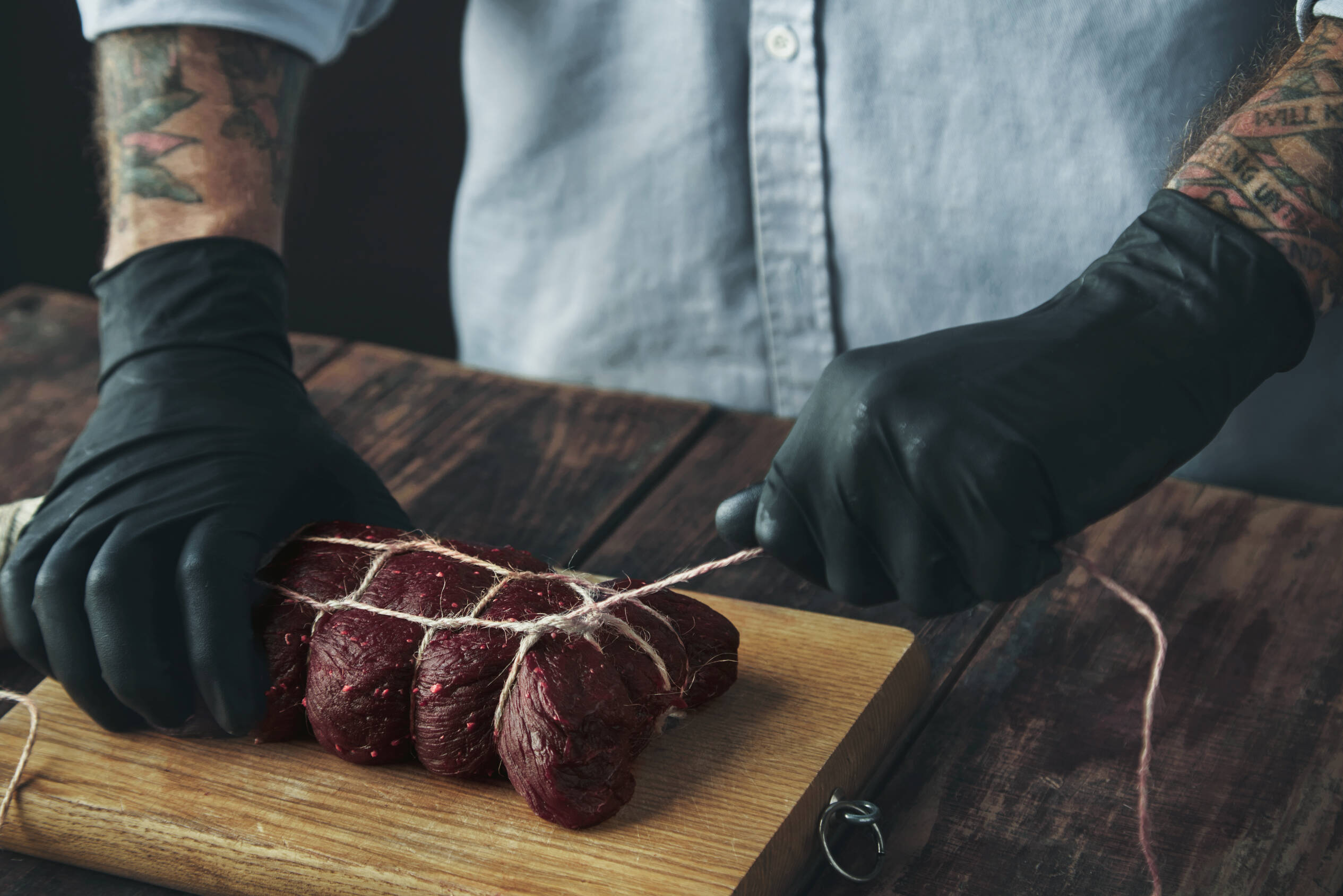 Butcher tying a roast